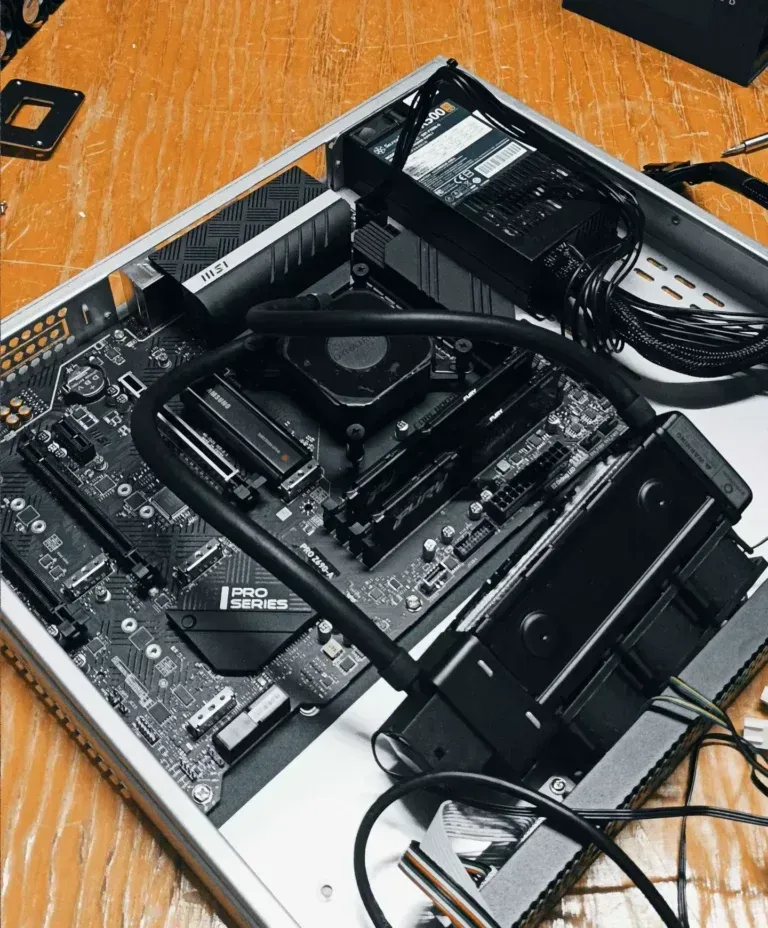 Liquid cooler and tubing mounted over the motherboard inside the original open Rearmed server chassis