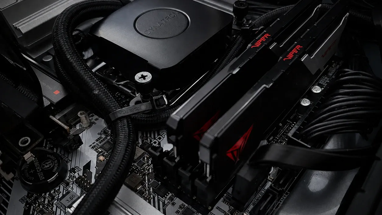 Liquid-cooling pump, tubing and memory inside a VYKIX server build.